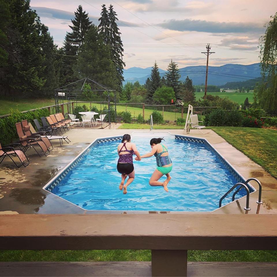 Two Girls Jumping Into Pool